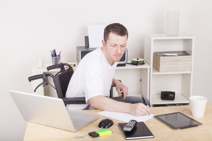 A man in a wheelchair with assistance technologies